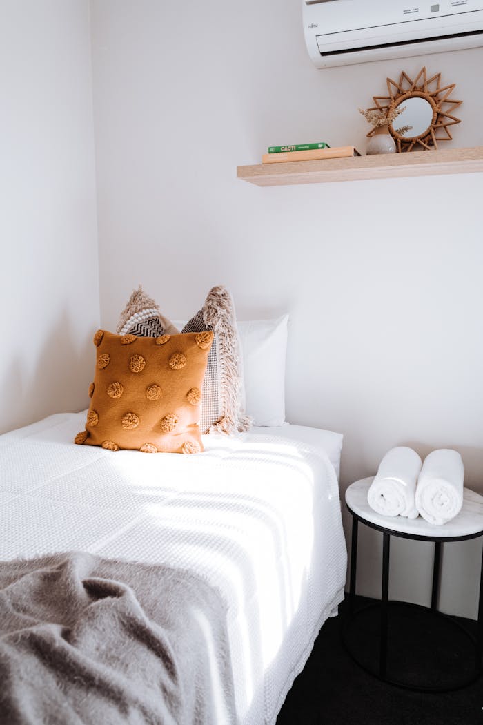 The Art of Drawing Readers In: Your attractive post title goes here A bright and cozy minimalist bedroom with textured cushions and elegant furniture.